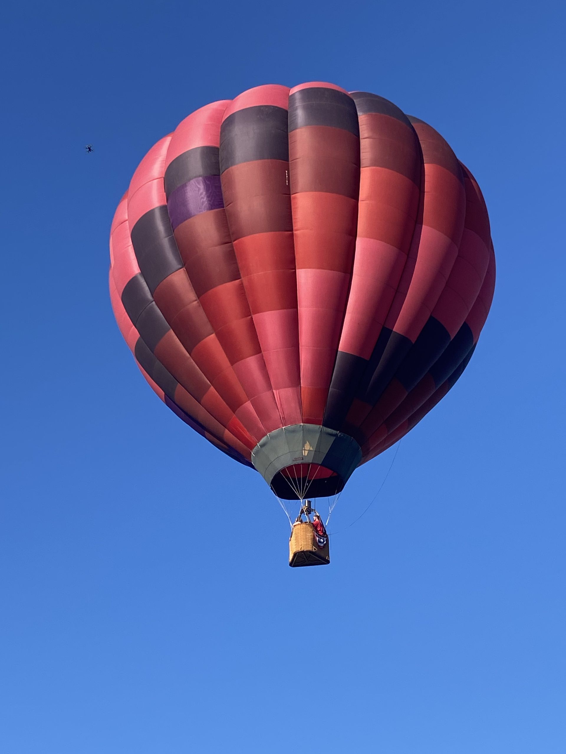 Balloon climbing into a clear blue sky