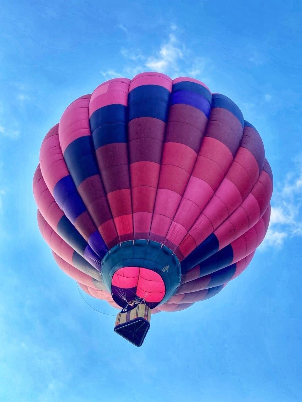 Balloon in flight against a deep blue sky