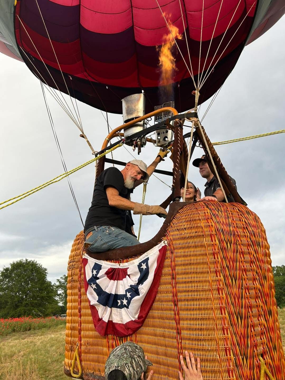 Pilot at the burner with guests in the basket
