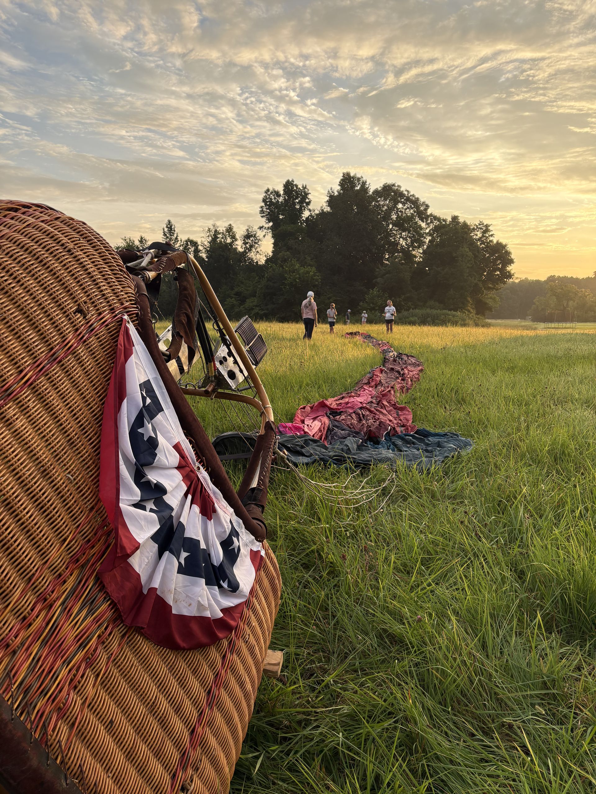 Flag-draped basket resting in the field